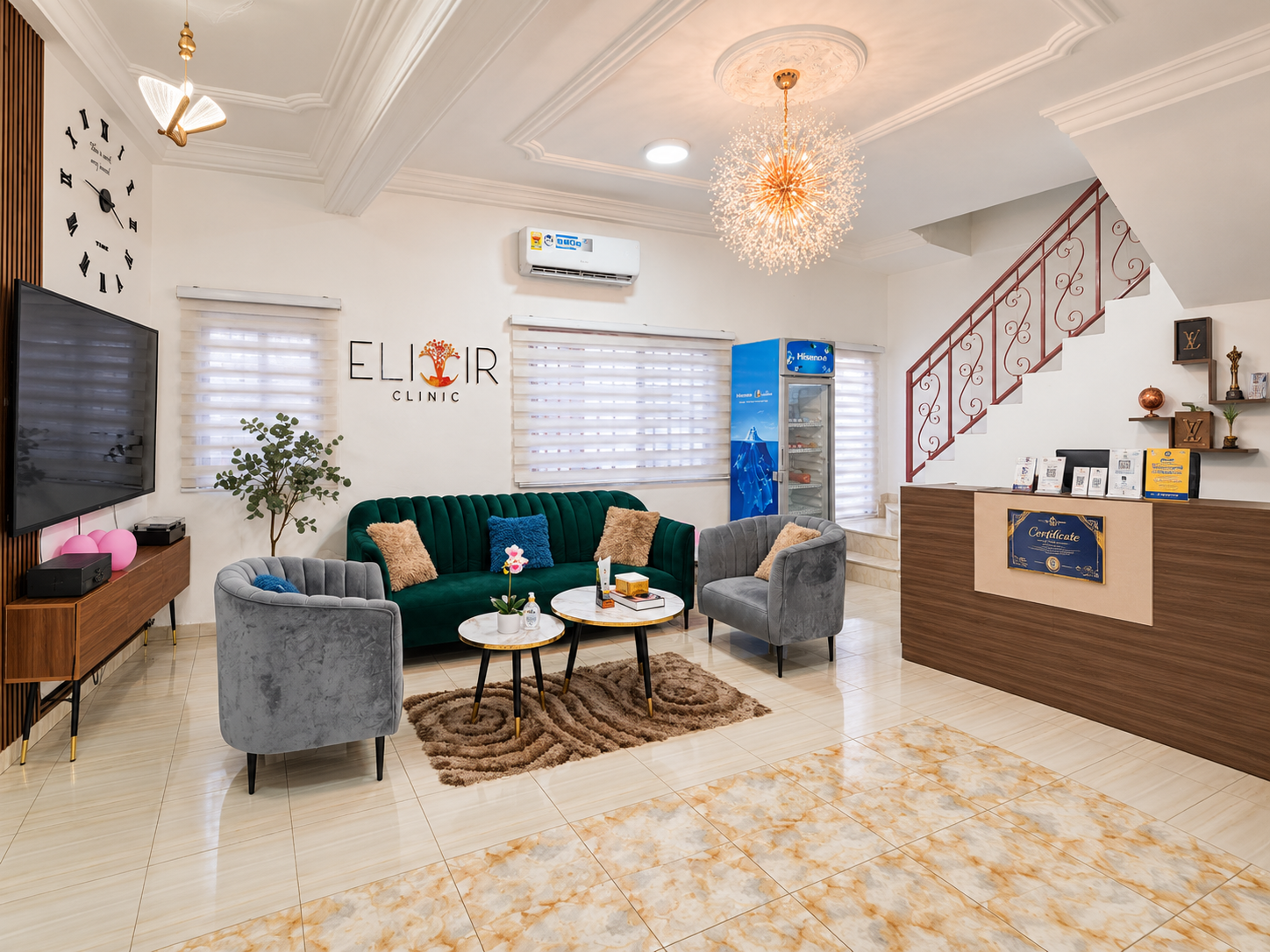 Elixir Clinic's reception area in East Legon, with an emerald sofa, armchairs and the clinic's front desk beneath the staircase.